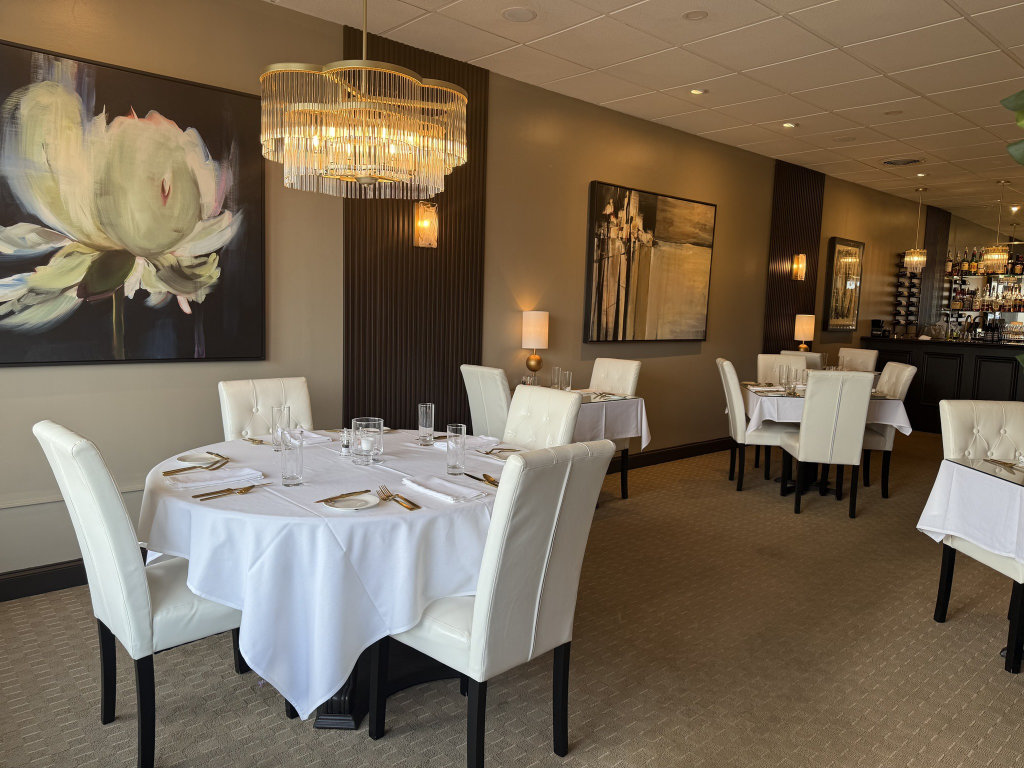 Bijou Bistro main dining room with intimate candlelit tables and elegant décor